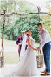 Bride and Groom Hold Hands at Altar - Rebecca Stevenson Photography